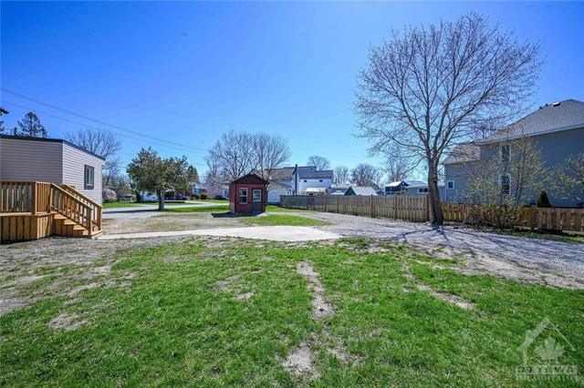 Grass seed is sprouting in areas of this huge spacious yard. | Image 24