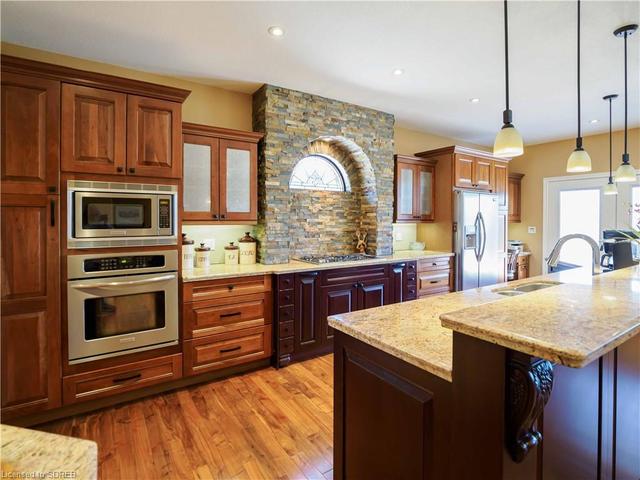 Custom kitchen including 5 burner gas stove and built-in's plus pantry and more! | Image 48