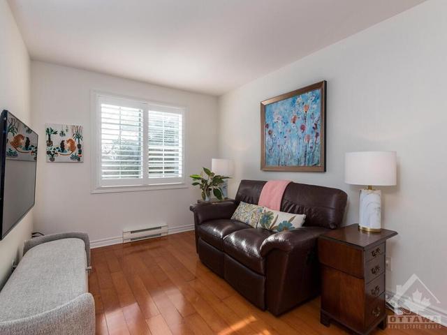 2nd main floor Bedroom is currently being used as a den/tv room featuring hardwood flooring! | Image 20