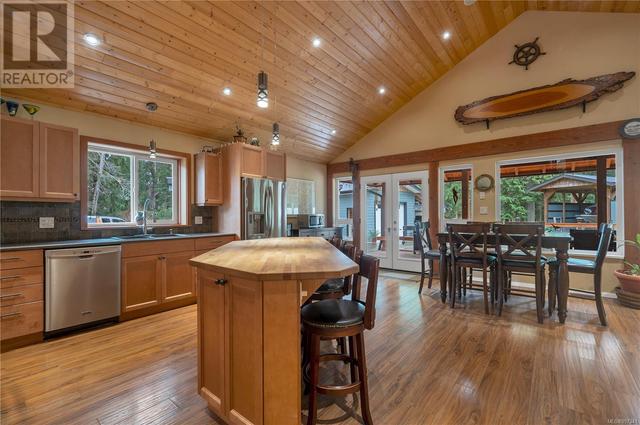 kitchen looking toward dining area, French doors to back covered deck | Image 17