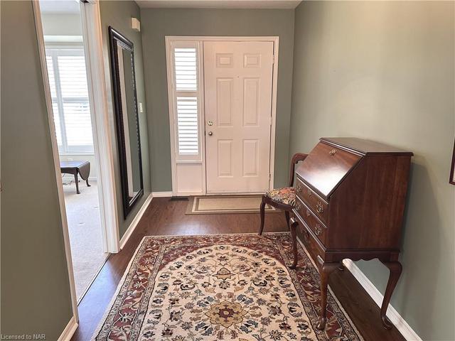 The hallway with bedroom/den off to the right of the front door. | Image 34