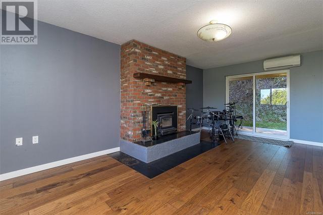 Lower level living room with wood burning fireplace insert | Image 37