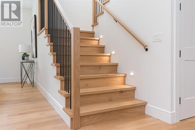 Lite stairwell leading to upstairs bedrooms and lounge area | Image 28