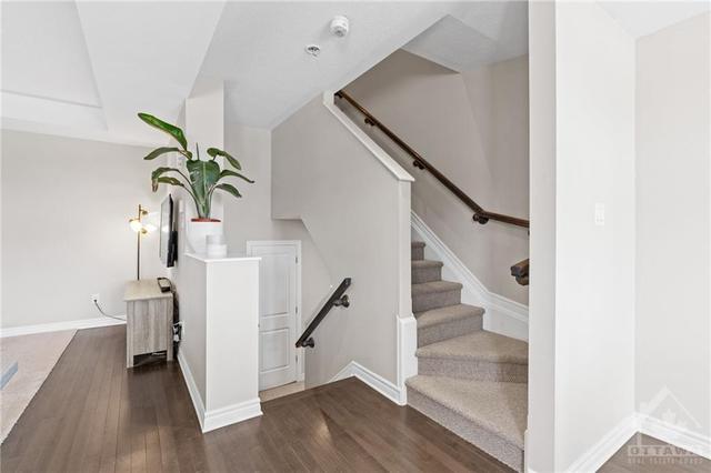 The entrance to the 2nd level- Carpet stairs & Hardwood flooring. | Image 9
