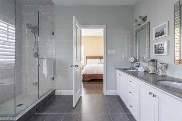 Primary ensuite with double-sinks, soaker tub and walk-in shower. | Image 9