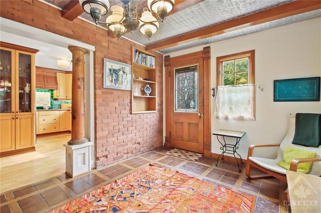 Eating area off of the kitchen with rear yard access. Note the decorative ceiling and period light fixture. | Image 12