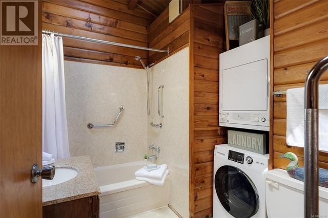 The stacking washer and dryer are in the main bathroom | Image 19