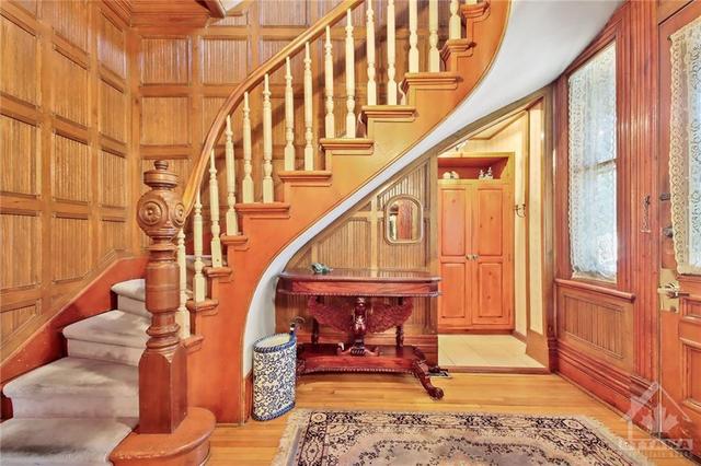 Large front entrance, access to the main floor powder room, hall closet and second level.   Lots of natural wood finishings. | Image 14