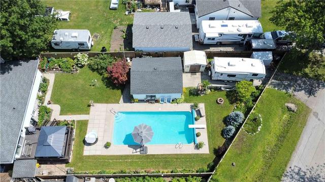 Here is a great view of the yard - pool - plenty of green space - detached oversized garage - RV parking all completely privacy fenced in | Image 26