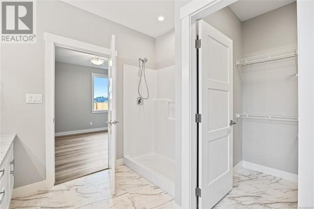 Ensuite with quartz counters, double sinks, walk-in shower and access to walk-in closet | Image 27