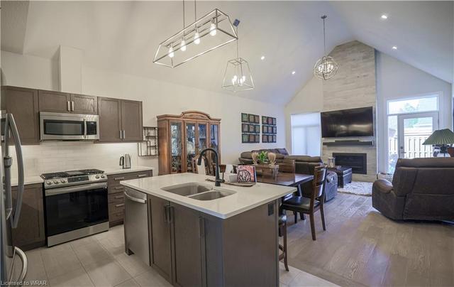Stainless steel appliances, a center island, and a backsplash. | Image 18