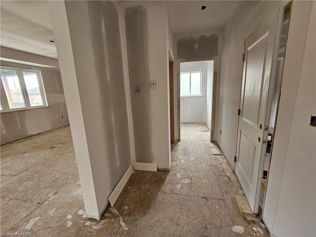 View of hallway to 2pc bath, entry from garage into main floor | Image 3