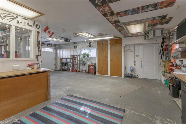 Garage/workshop has a gas heater, wall mounted a/c and sandpoint well pump. | Image 35