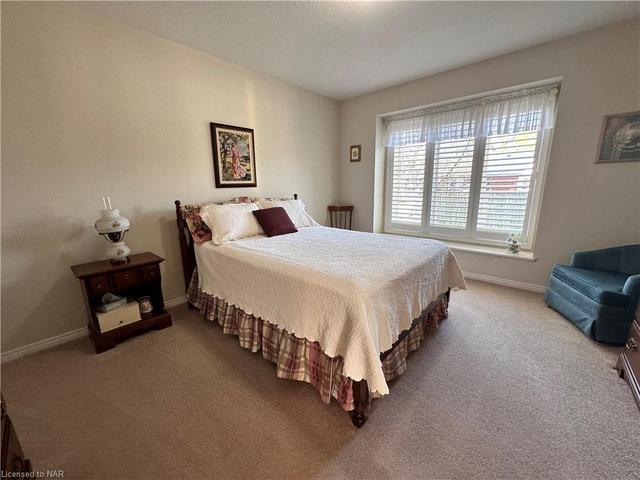 The good sized primary bedroom with large windows; again, with attractive California blinds. | Image 10