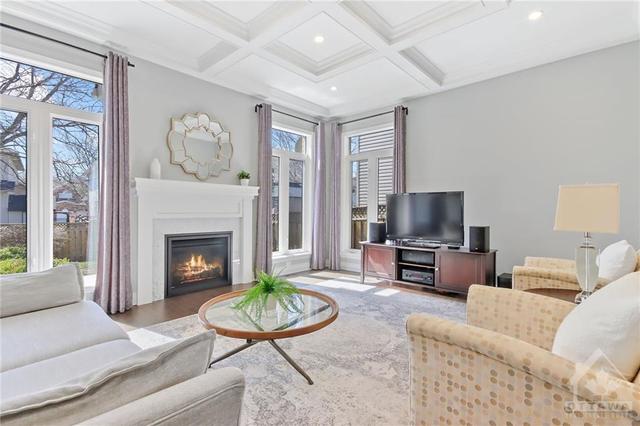 Large familyroom offers gas fireplace and captivating tray ceilings | Image 11