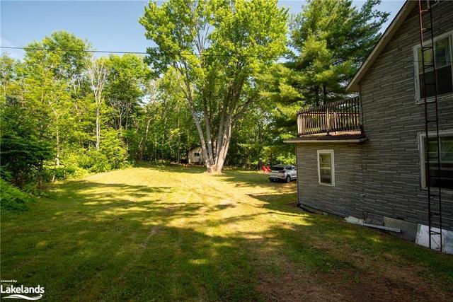 From the back of the cottage looking towards the Bunkie.  This is an amazing opportunity to rebuild your dream cottage or perhaps create a parking area (you can drive right to the dock/boathouse) for | Image 19