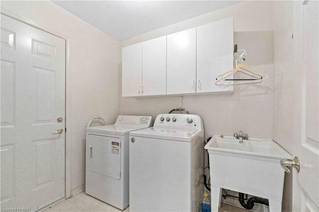 Here is the main floor laundry room - the door to the left is the interior entry from the Attach garage - an excellent space - not just a closet with the washer & dryer enclosed on a hall but a real dedicated spot.  That helps to chase away those laundry day blues | Image 20
