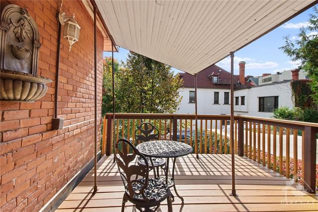 Rear partially covered terrace/balcony overlooks rear yard.  Perfect for those quiet reading hours. | Image 20