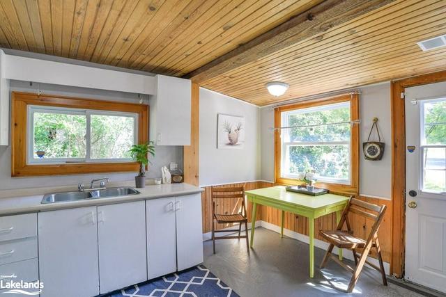 Bright, easy flow kitchen, wood touches with new fridge, external door is on Muskoka Rd side | Image 12
