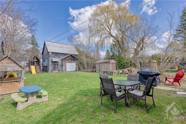 Huge backyard with a play house, play structure, and your own barn! Perfect as a studio or workshop. | Image 2
