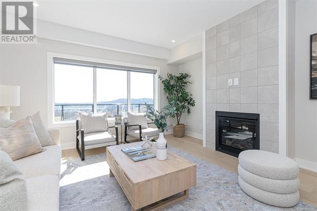 Living room with gas fireplace. Photo of staged show home of similar plan, not exact unit. | Image 3