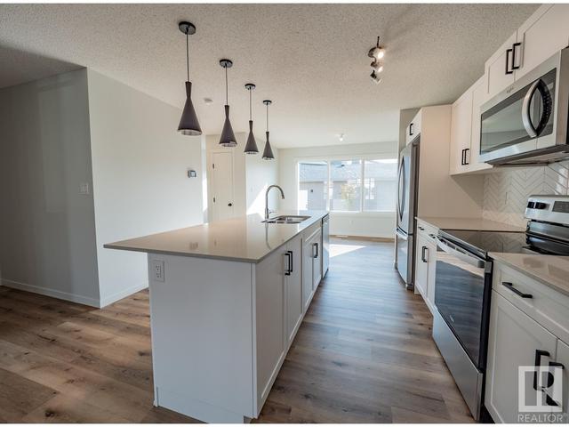5718 Juchli Av Nw, House attached with 3 bedrooms, 3 bathrooms and null parking in Edmonton AB | Card Image
