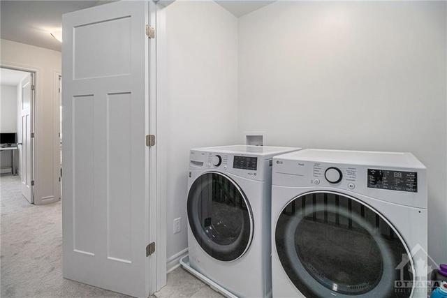 The second-floor laundry, neatly tucked in a closet, offers discreet yet accessible convenience for handling laundry needs seamlessly. | Image 19