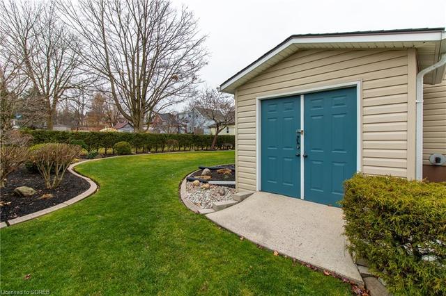 Street view. Double garage with room to park 2 vehicles in asphalt laneway. | Image 34