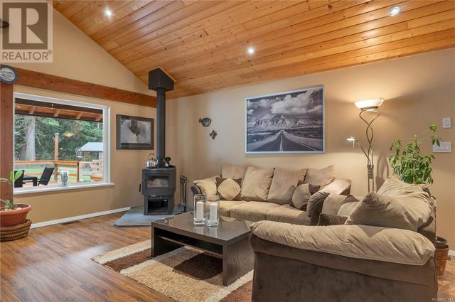 living room, woodstove on custom cement pad | Image 26