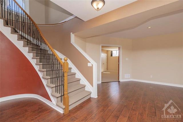 Beautiful spiral staircase leading down to your fully finished lower level with a walkout. | Image 22
