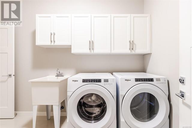 Laundry room with upper cabinet and closet storage | Image 19