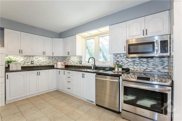 Kitchen with Granite Counter-top, Backsplash & SS Appliances | Image 11