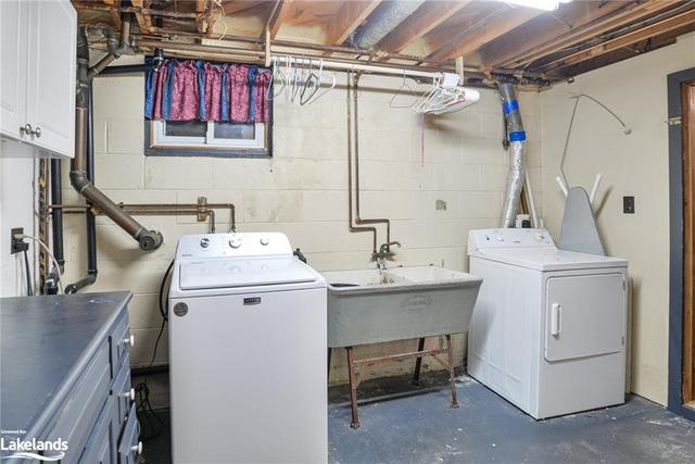 Laundry room with an additional door into a storage room. Concrete sink non-functional. | Image 10