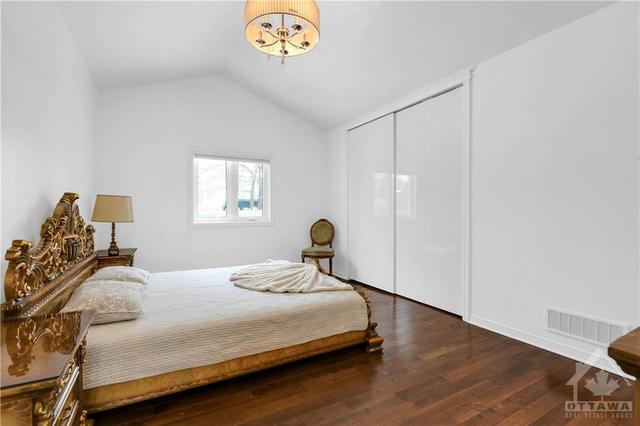 The primary bedroom enjoys cathedral ceilings and an ensuite bathroom | Image 15
