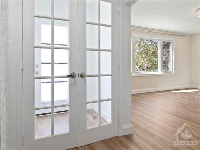 Greeted with French Doors from Foyer to Living. | Image 4