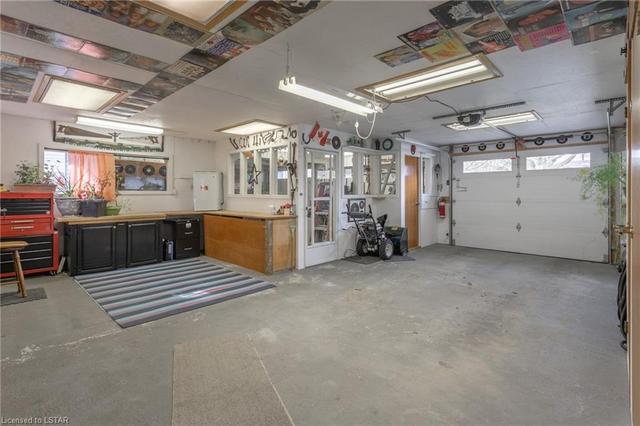 Garage/workshop with work bench area(s) and tons of storage. | Image 30
