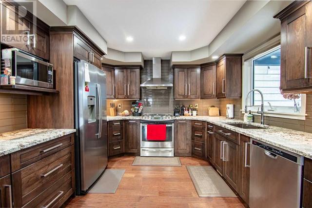 Wood cabinets, granite countertops, stainless appliances | Image 3