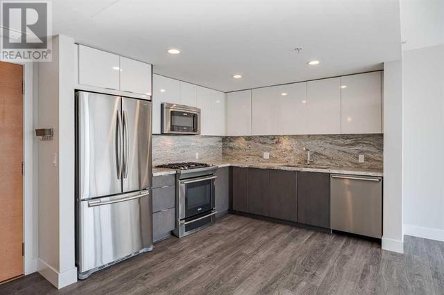 Open concept with granite, backsplash and upgraded appliances including gas stove | Image 2