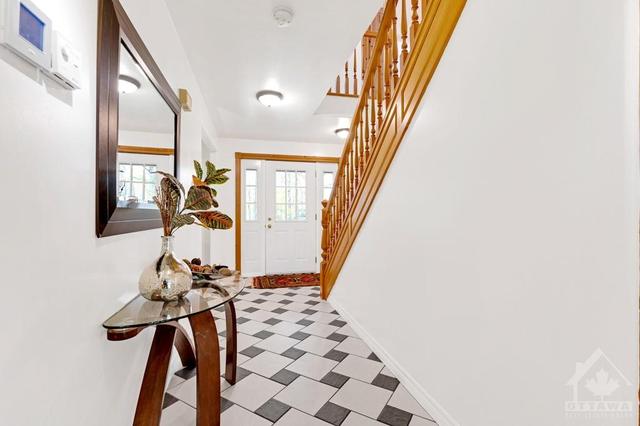Welcoming you home is white bright foyer with dramatic tiled floor | Image 4