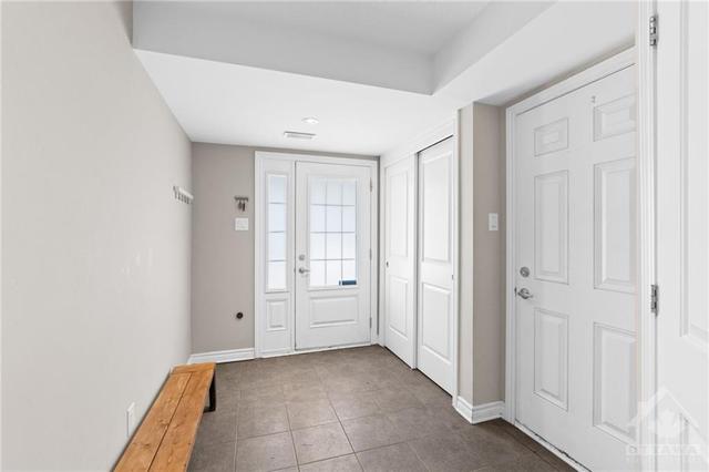 Spacious tiled front foyer/mud room w/ access to the garage. | Image 5