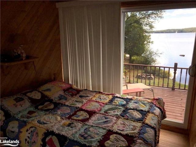 Bedroom with Walkout to Deck with View of Lake Bernard | Image 24