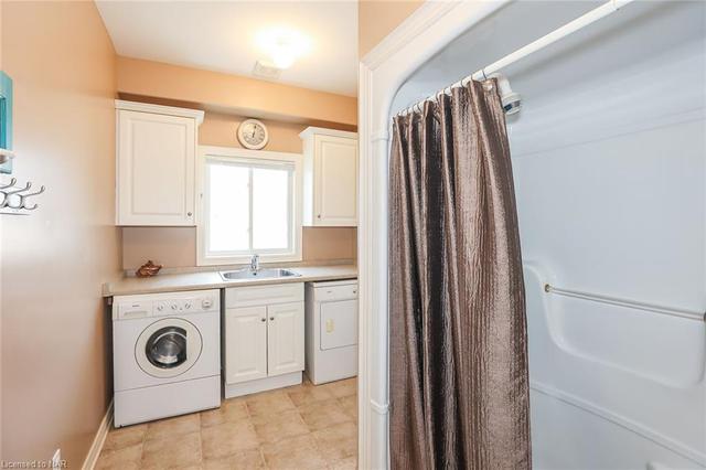 Main floor laundry with shower & access to garage | Image 1