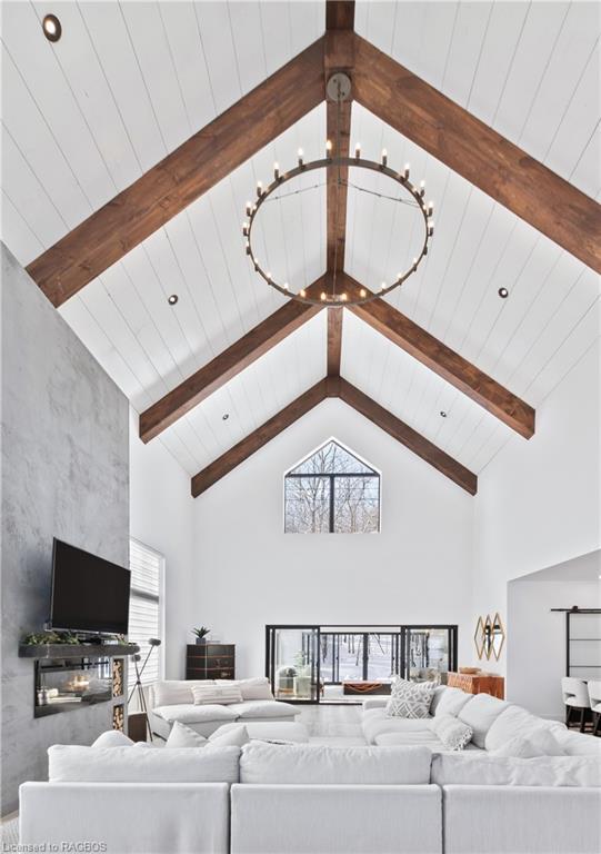 The 30 ft vaulted ceiling merits attention—it’s a beautiful overhead canvas with exposed timber beams and subtle shiplap details. | Card Image