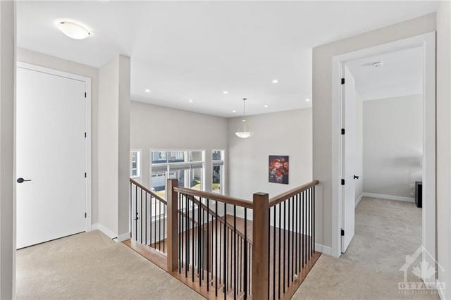 Upper level main hallway, linen closet & view down to great room. | Image 21