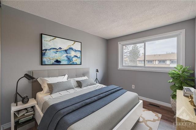 Additional bedroom on the second level offers a large bright window and laminate floors. (virtually staged). | Image 20