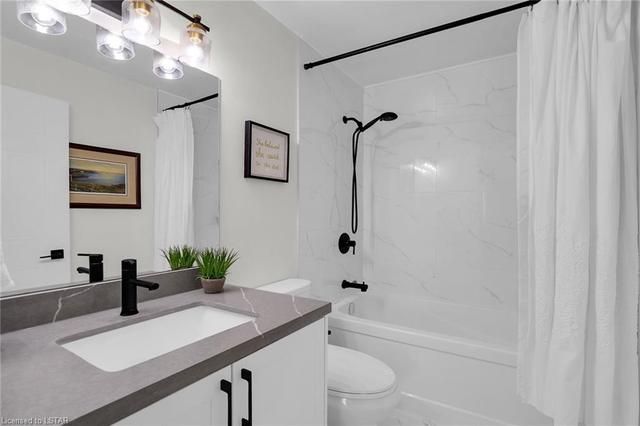 Main bath with new tile, bathtub, cabinets, quartz | Image 16