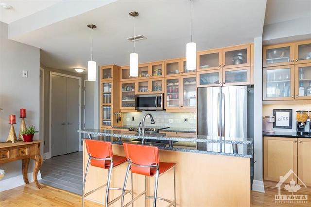 Generously sized eat-up kitchen with a custom breakfast bar | Image 4
