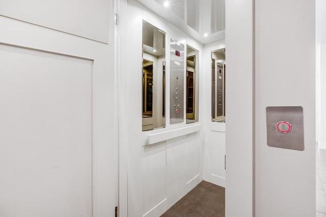Massive mudroom with storage, 2 washers and dryers, elevator, and full bathroom off the garage | Image 25