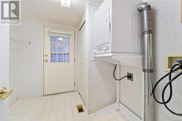 Large laundry room with walk-out to the patio | Image 26