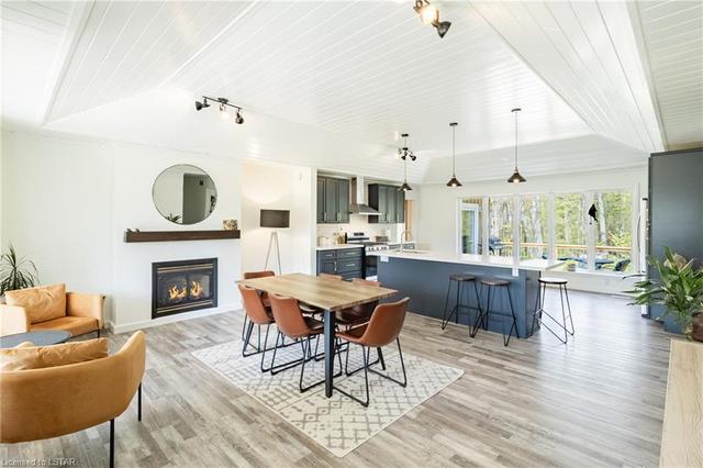 A quick preview of this new kitchen & renovated open-concept great room featuring a gas fireplace (1 of 3 fireplaces) all perfectly laid-out below a vaulted shiplap tray ceiling. | Image 12